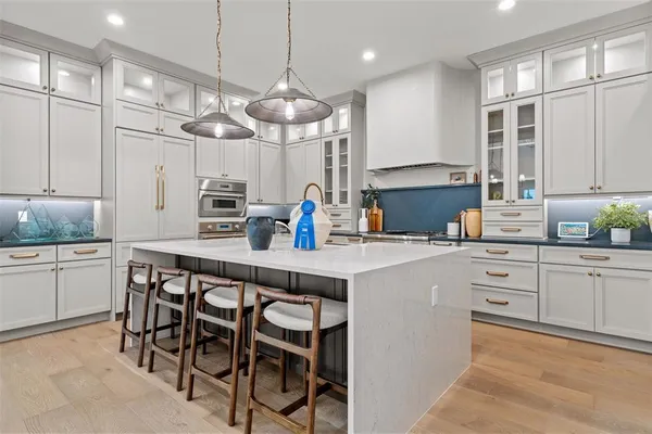a kitchen with cabinets a center island and appliances