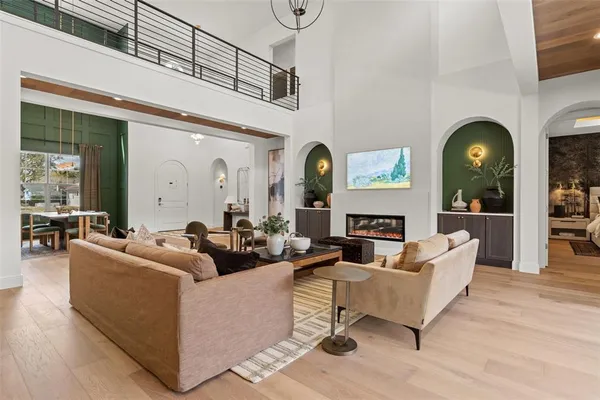 a living room with fireplace furniture and a large window