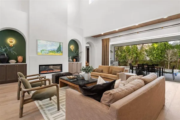 a living room with fireplace furniture and a large window