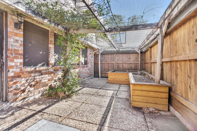 a view of a bench in back yard of a house