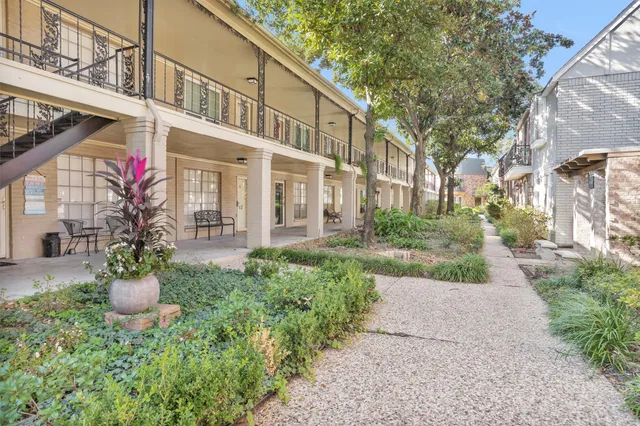 a view of a house with a small yard and plants