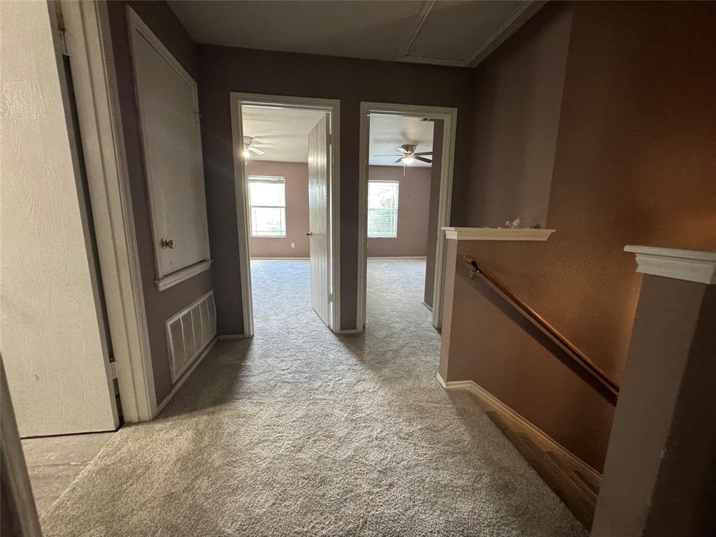 3200 Crownover Street Austin, TX 78725 - Photo 10 of 23 A well-lit landing provides access to rooms with comfortable carpeting and window views.
