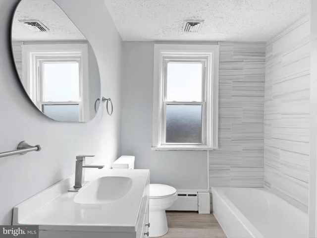 a bathroom with a sink toilet and tub