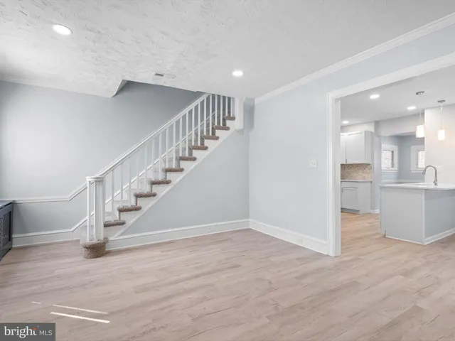 a view of entryway and hall with wooden floor