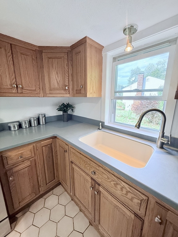975 South Main Street Bellingham, MA 02019 - Photo 23 of 38 a kitchen with stainless steel appliances granite countertop a sink dishwasher and cabinets with wooden floor