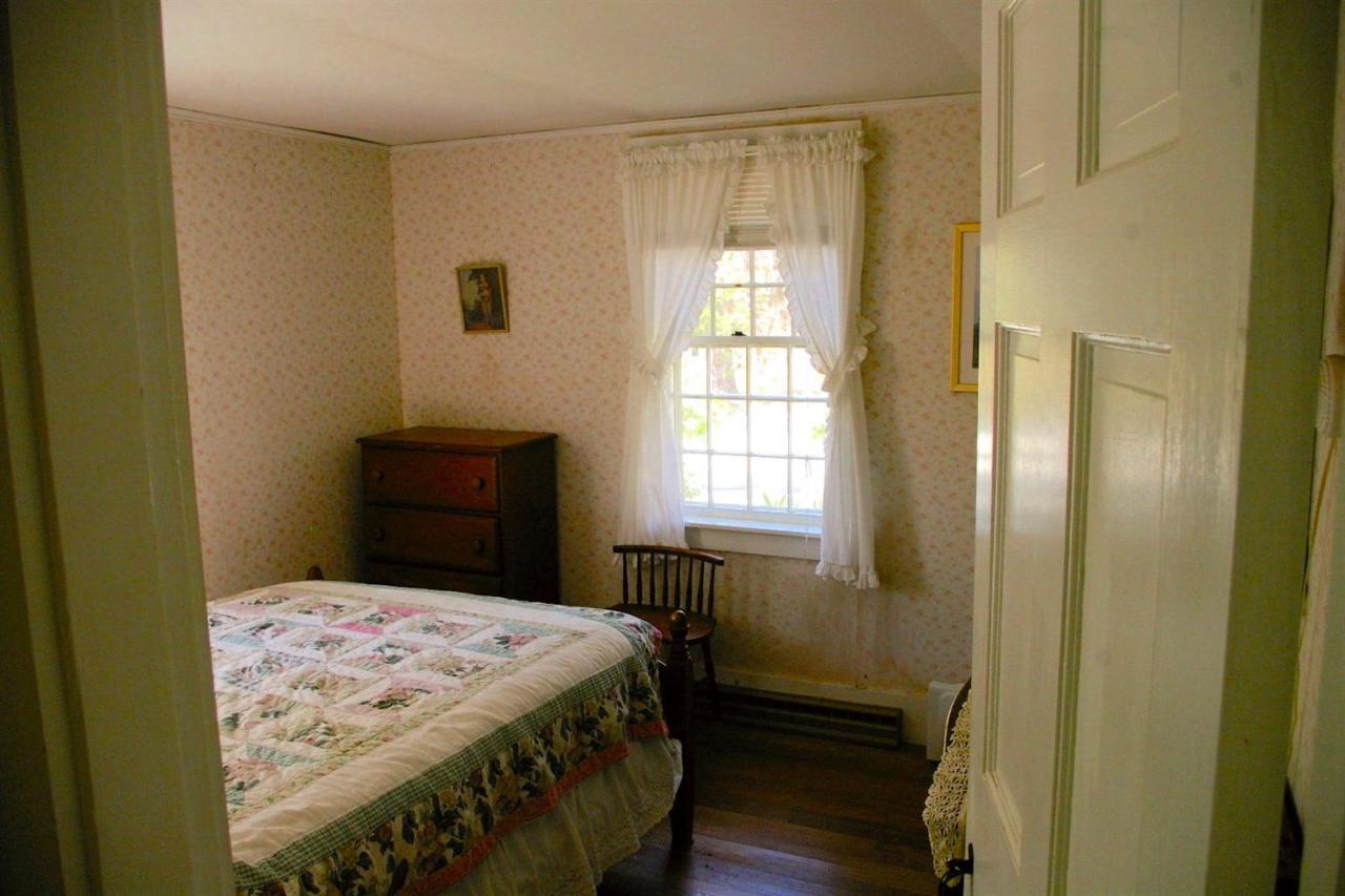 125 Mill Hill Road Wellfleet, MA 02667 - Photo 11 of 22 a bedroom with a bed and a window
