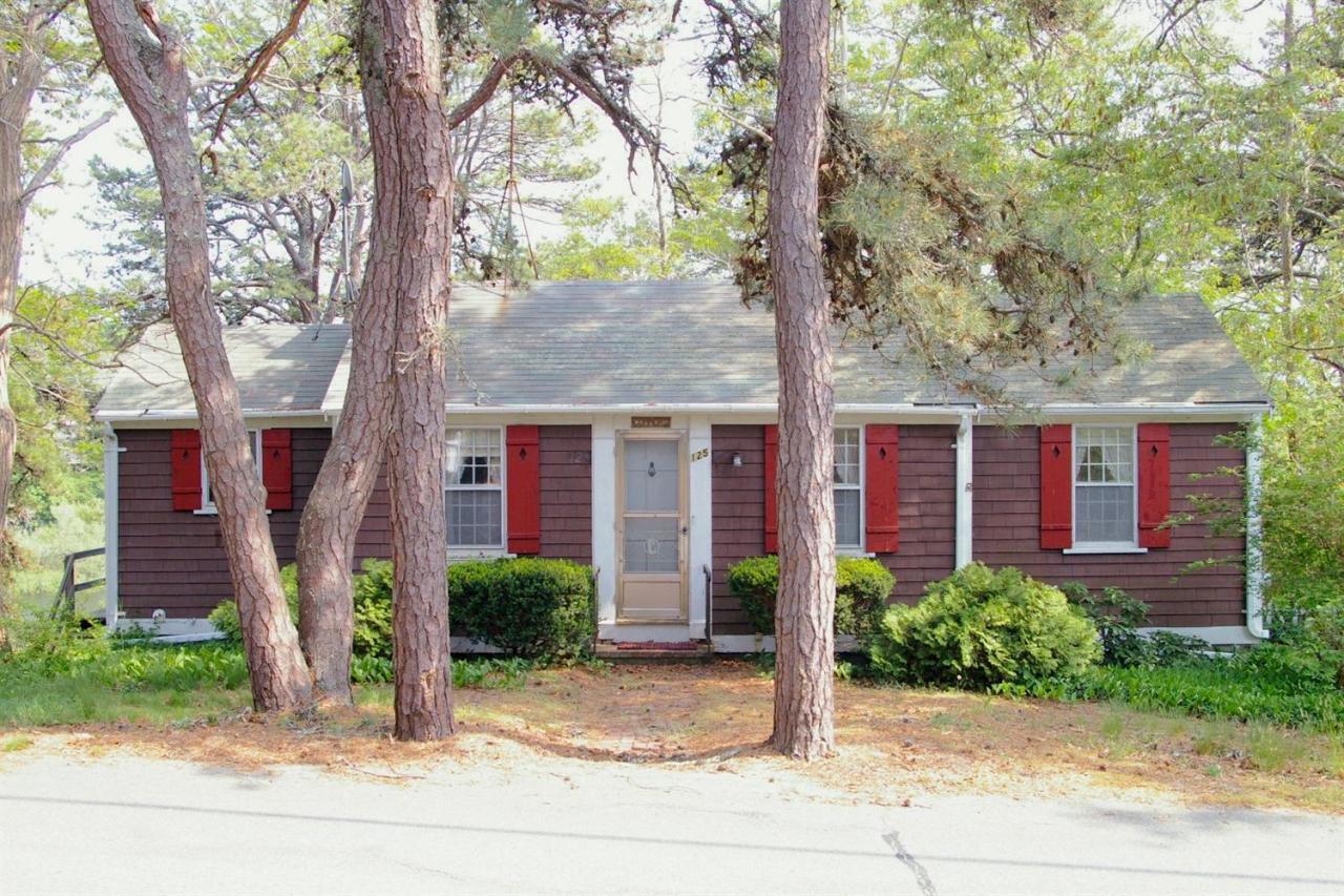 125 Mill Hill Road Wellfleet, MA 02667 - Photo 2 of 22 a front view of a house with garden