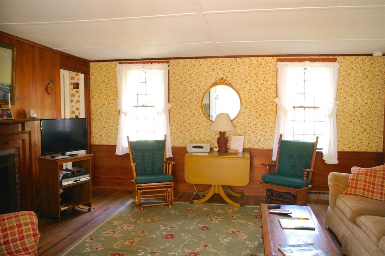 125 Mill Hill Road Wellfleet, MA 02667 - Photo 7 of 22 a living room with furniture a flat screen tv and a large window