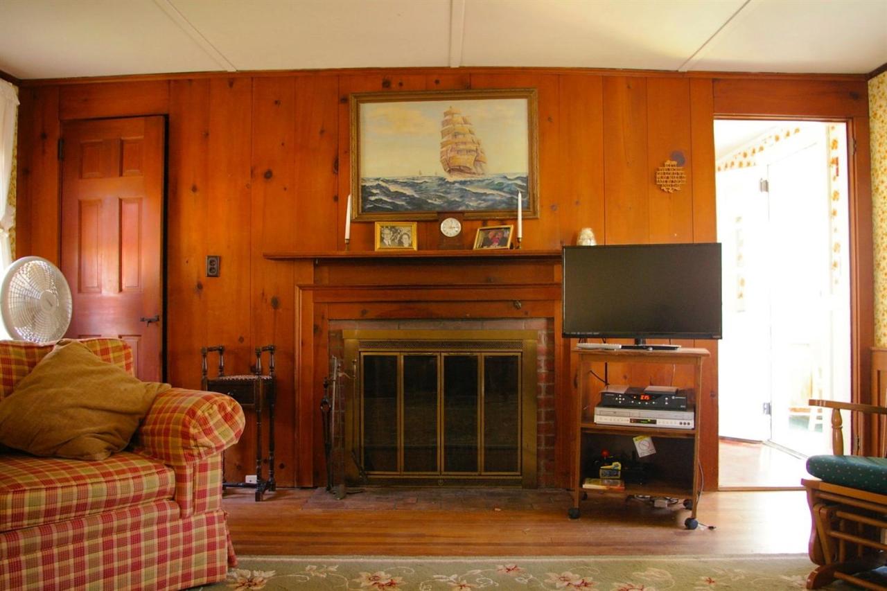 125 Mill Hill Road Wellfleet, MA 02667 - Photo 8 of 22 a living room with furniture and a fireplace