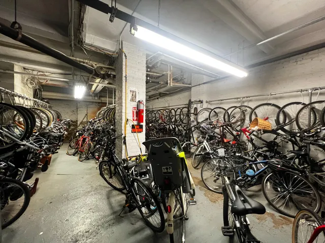 a living room with couches a dining table and chairs with wooden floor