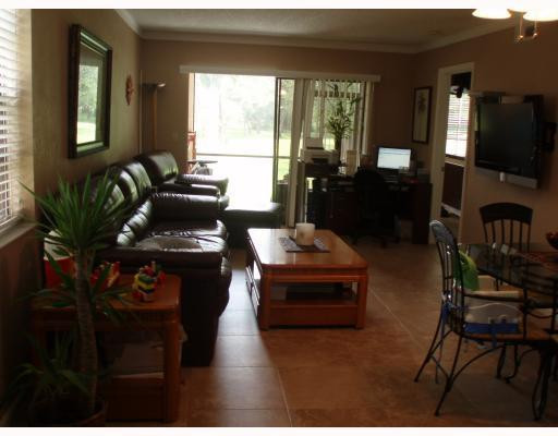 3151 Leewood Terrace, Unit L127 Boca Raton, FL 33431 - Photo 3 of 6 a living room with furniture and a flat screen tv