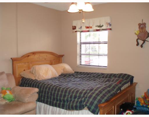 3151 Leewood Terrace, Unit L127 Boca Raton, FL 33431 - Photo 5 of 6 a bedroom with a bed and window