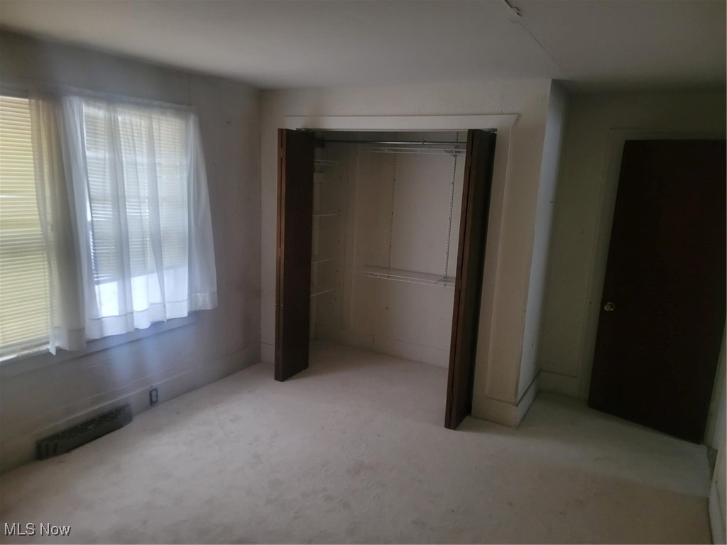 7631 Mines Road Southeast Warren, OH 44484 - Photo 12 of 22 Unfurnished bedroom with a closet and light colored carpet