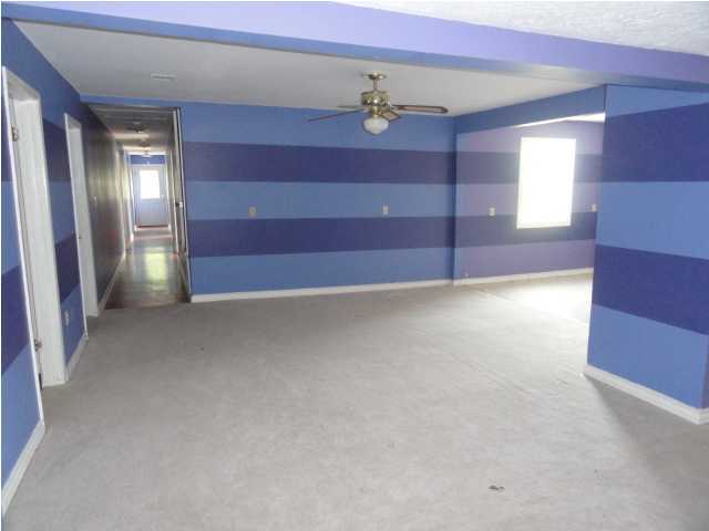 4291 Rebecca Road Crestview, FL 32539 - Photo 5 of 13 a view of an empty room with a chandelier fan and a window