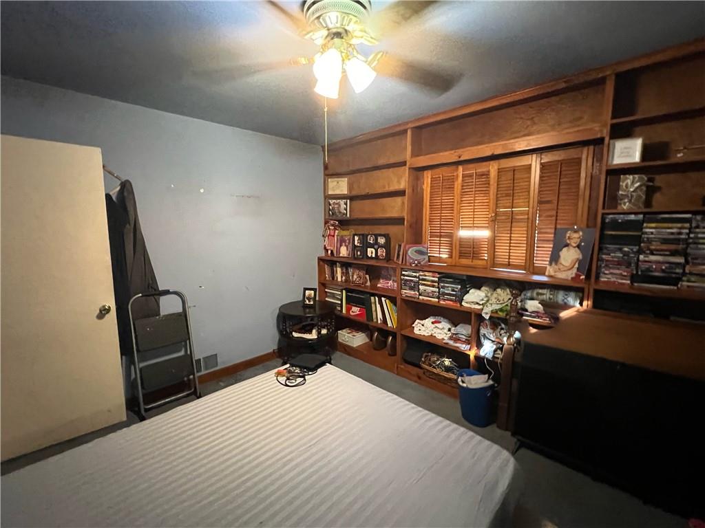 19 Fairview Street Uniontown, PA 15401 - Photo 14 of 19 a bedroom with furniture and a flat screen tv