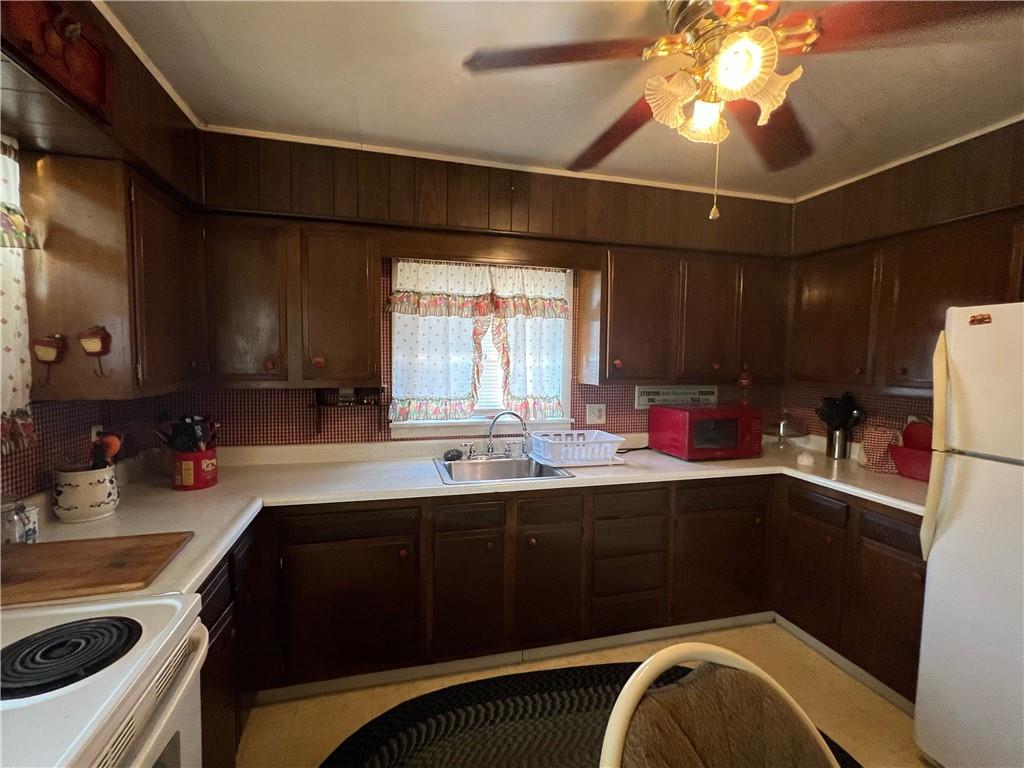 19 Fairview Street Uniontown, PA 15401 - Photo 9 of 19 a kitchen with a sink a stove and cabinets