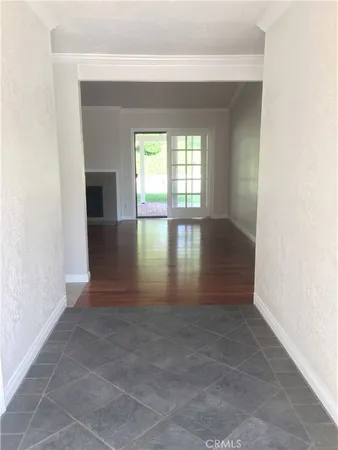 a view of empty room with wooden floor and fireplace