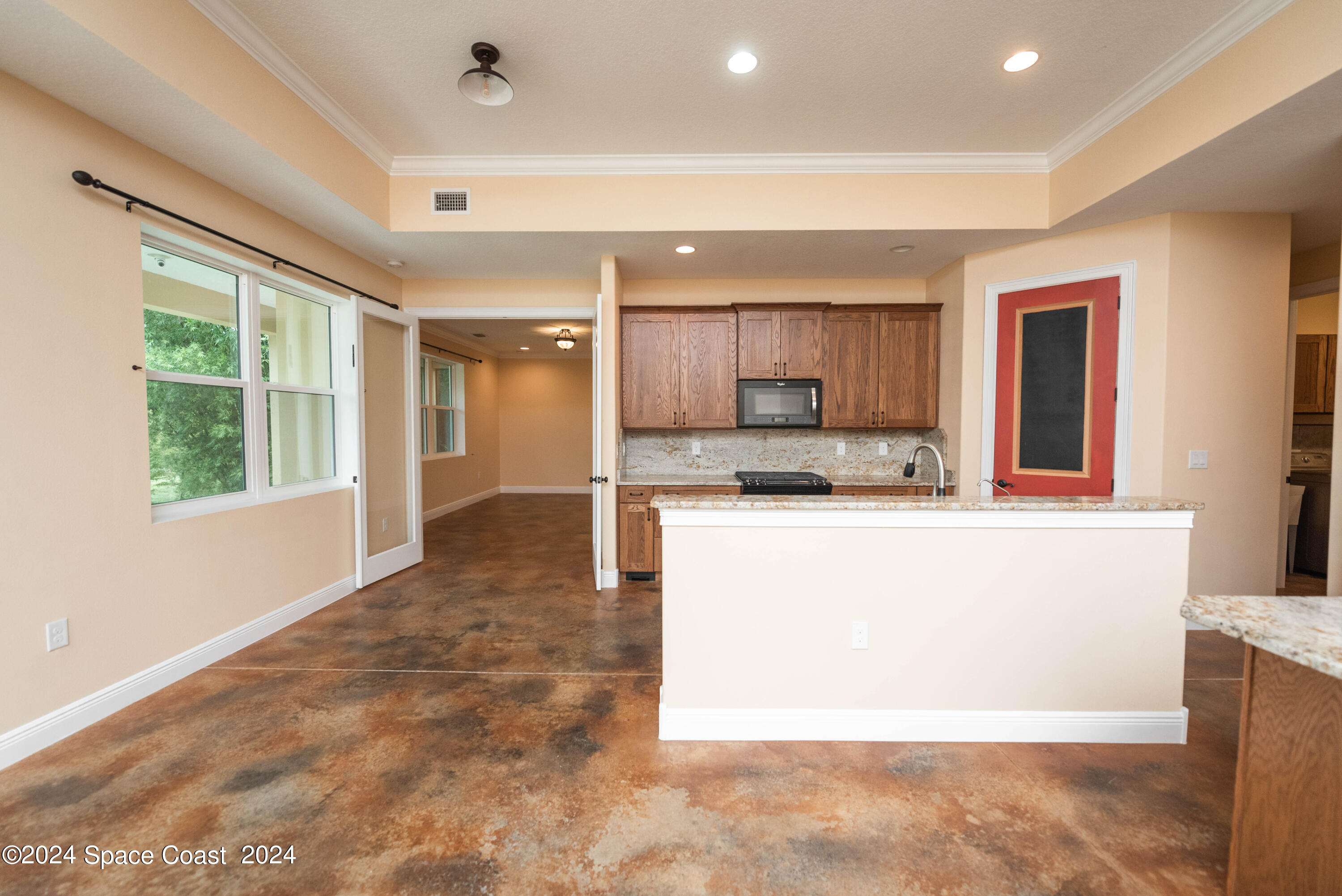 3750 Hield Road Melbourne, FL 32904 - Photo 11 of 63 a large kitchen with kitchen island a sink a counter top space and stainless steel appliances