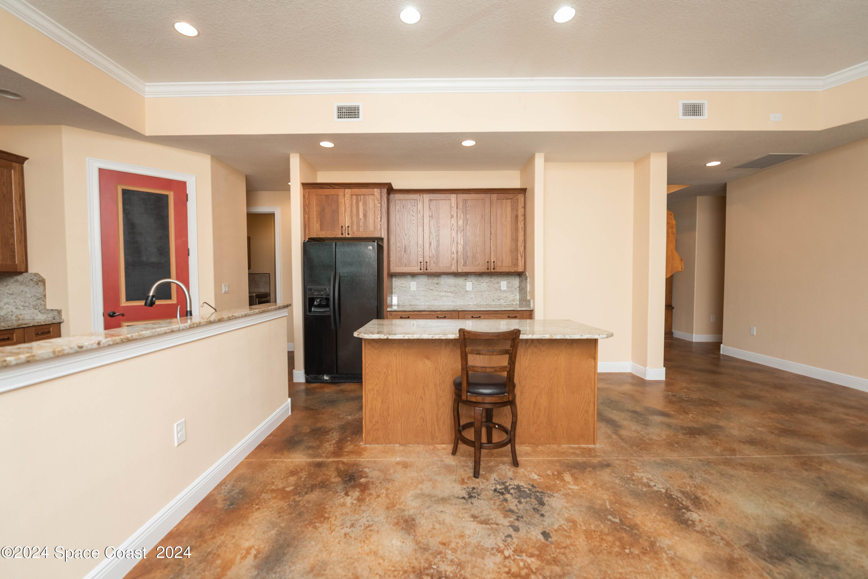 3750 Hield Road Melbourne, FL 32904 - Photo 12 of 63 a kitchen with granite countertop cabinets and refrigerator