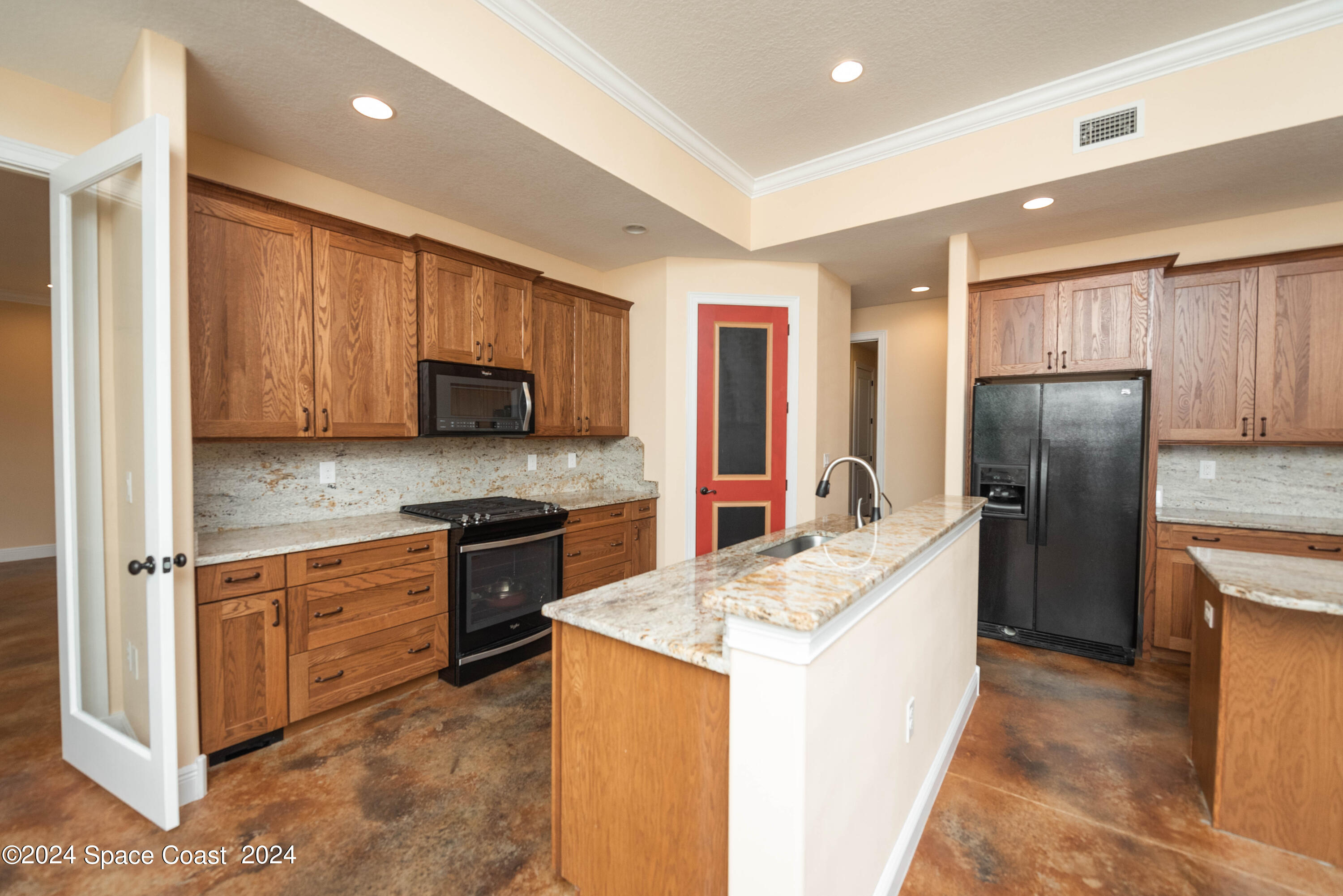 3750 Hield Road Melbourne, FL 32904 - Photo 16 of 63 a kitchen with stainless steel appliances granite countertop a refrigerator stove microwave and sink