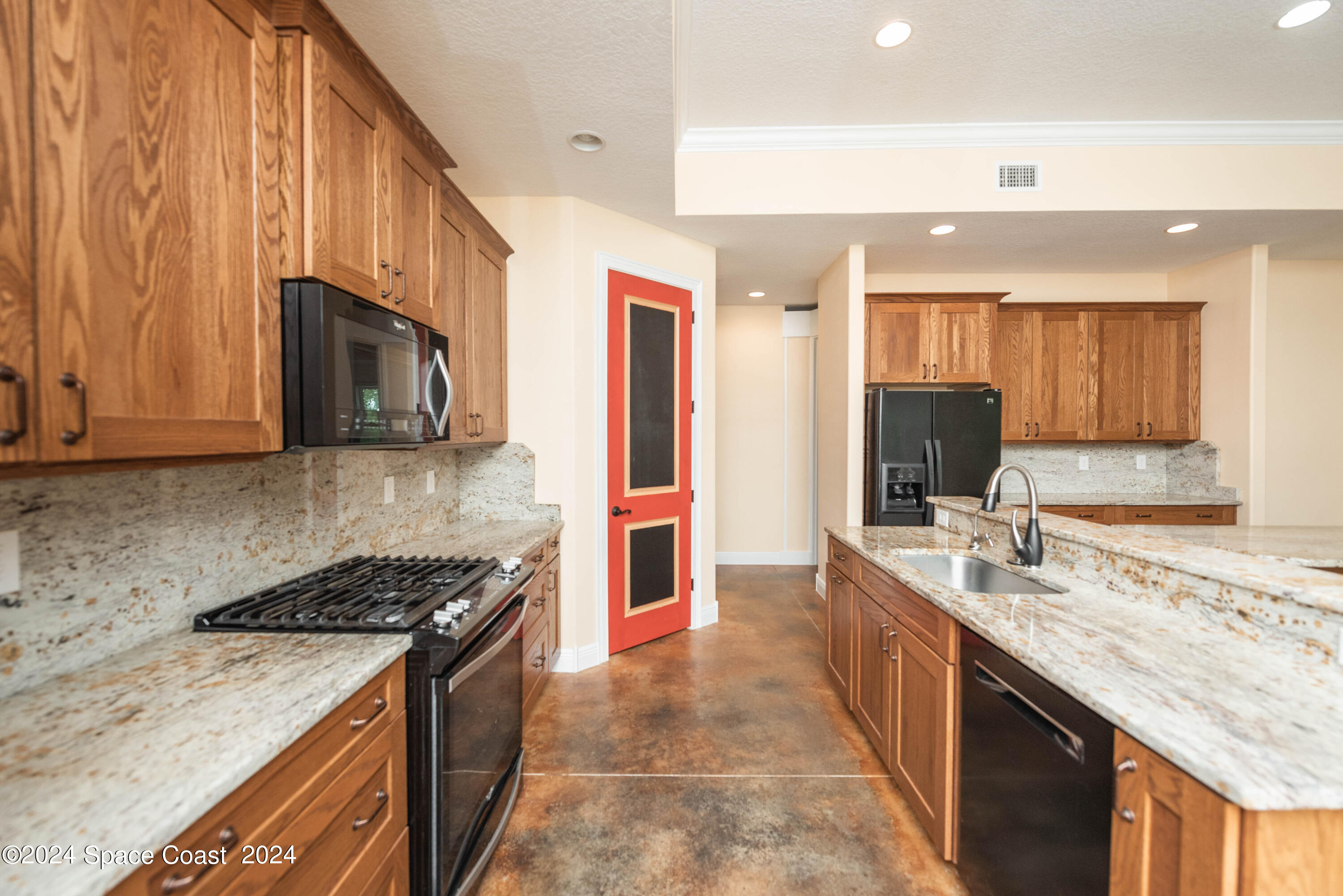 3750 Hield Road Melbourne, FL 32904 - Photo 17 of 63 a kitchen with stainless steel appliances granite countertop a sink stove and microwave