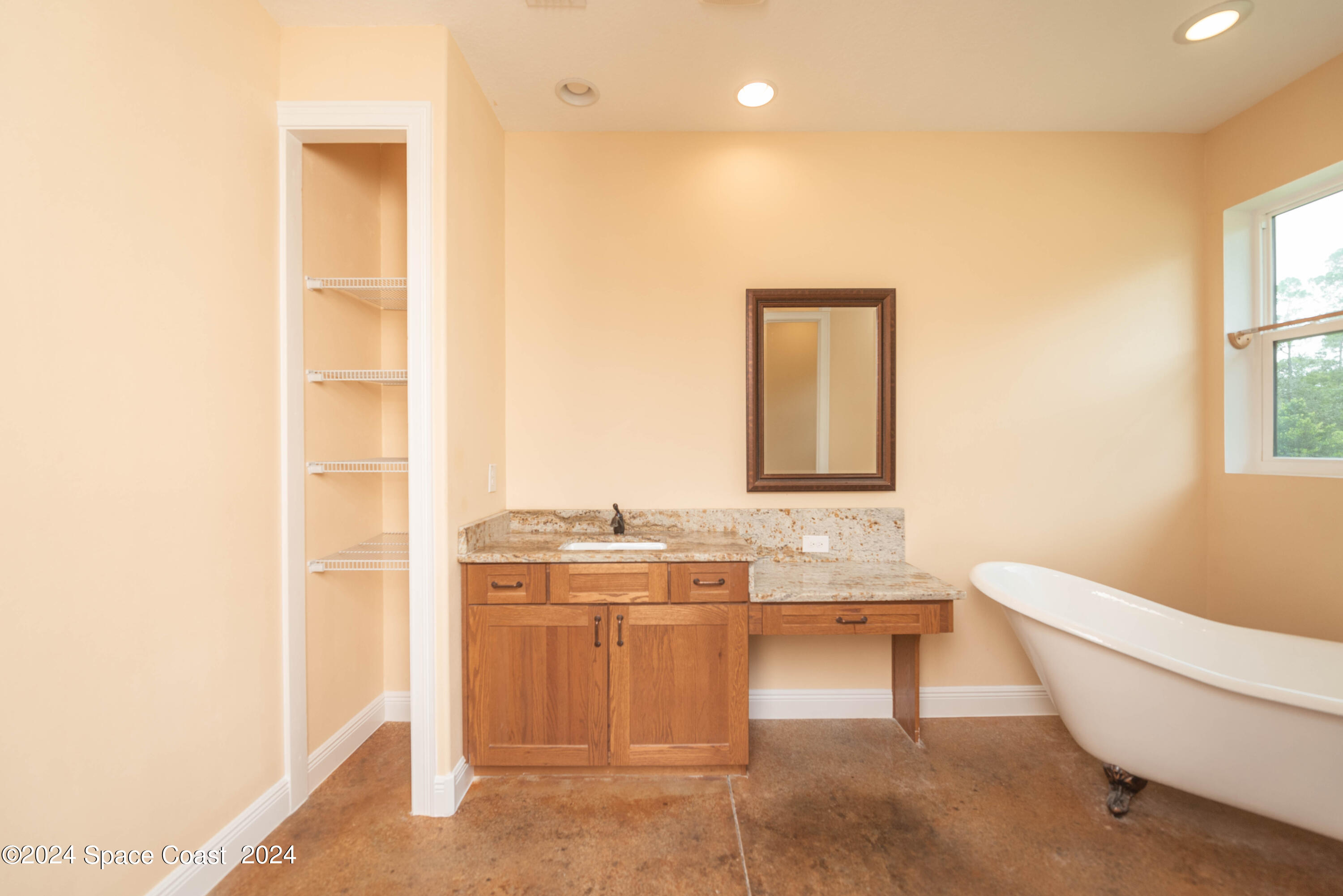 3750 Hield Road Melbourne, FL 32904 - Photo 27 of 63 a bathroom with a toilet sink and mirror