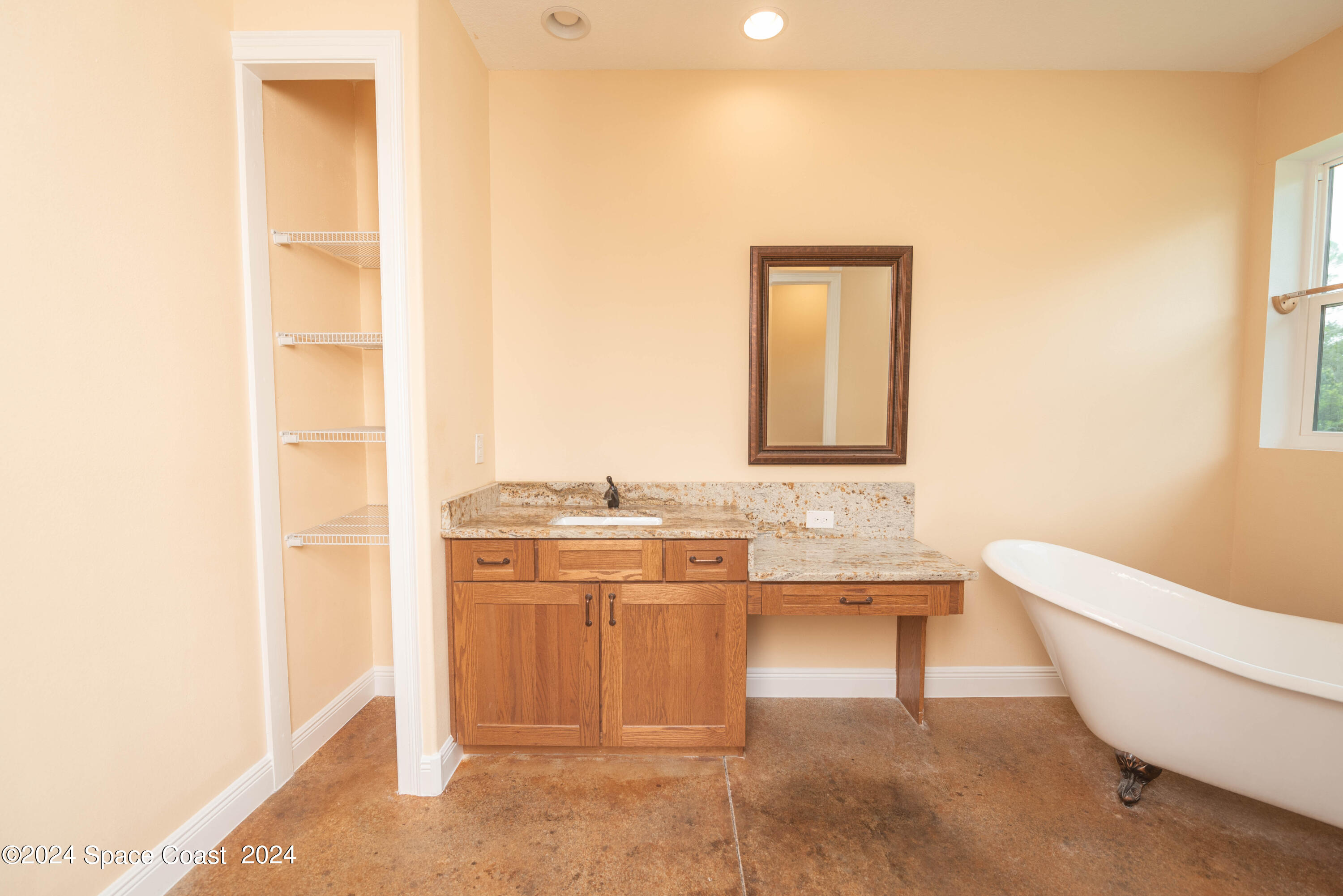 3750 Hield Road Melbourne, FL 32904 - Photo 29 of 63 a bathroom with a tub sink and mirror