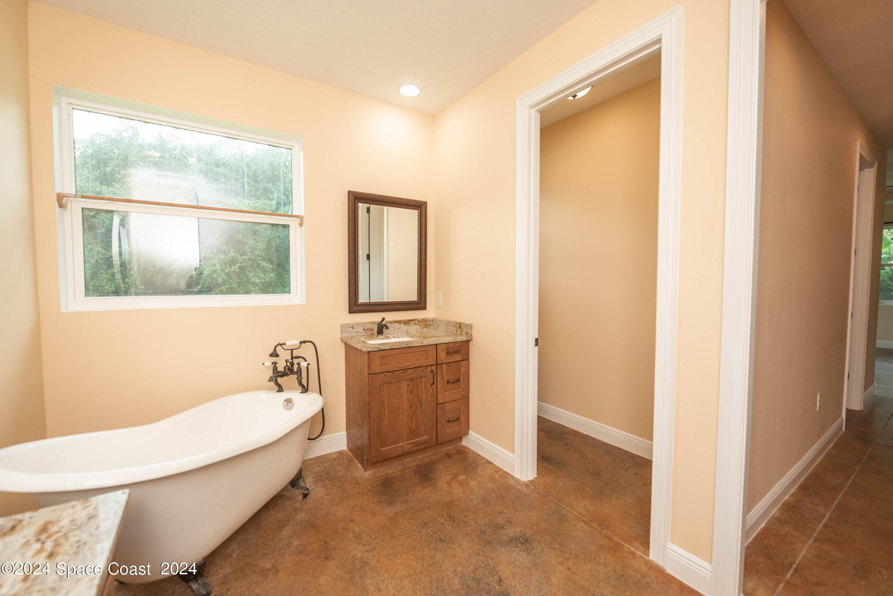 3750 Hield Road Melbourne, FL 32904 - Photo 30 of 63 a bathroom with a tub sink and mirror
