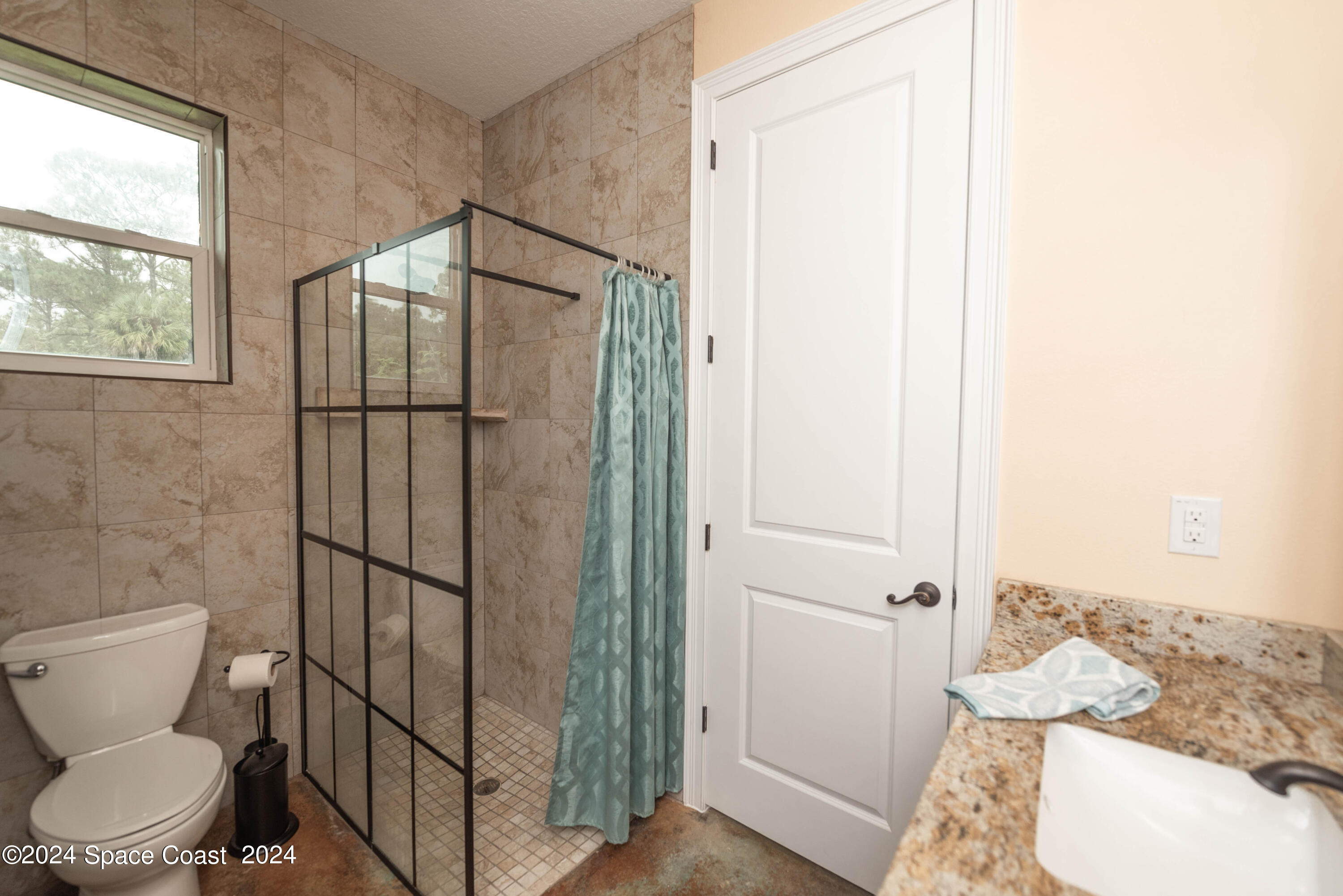 3750 Hield Road Melbourne, FL 32904 - Photo 35 of 63 a bathroom with a toilet and a shower