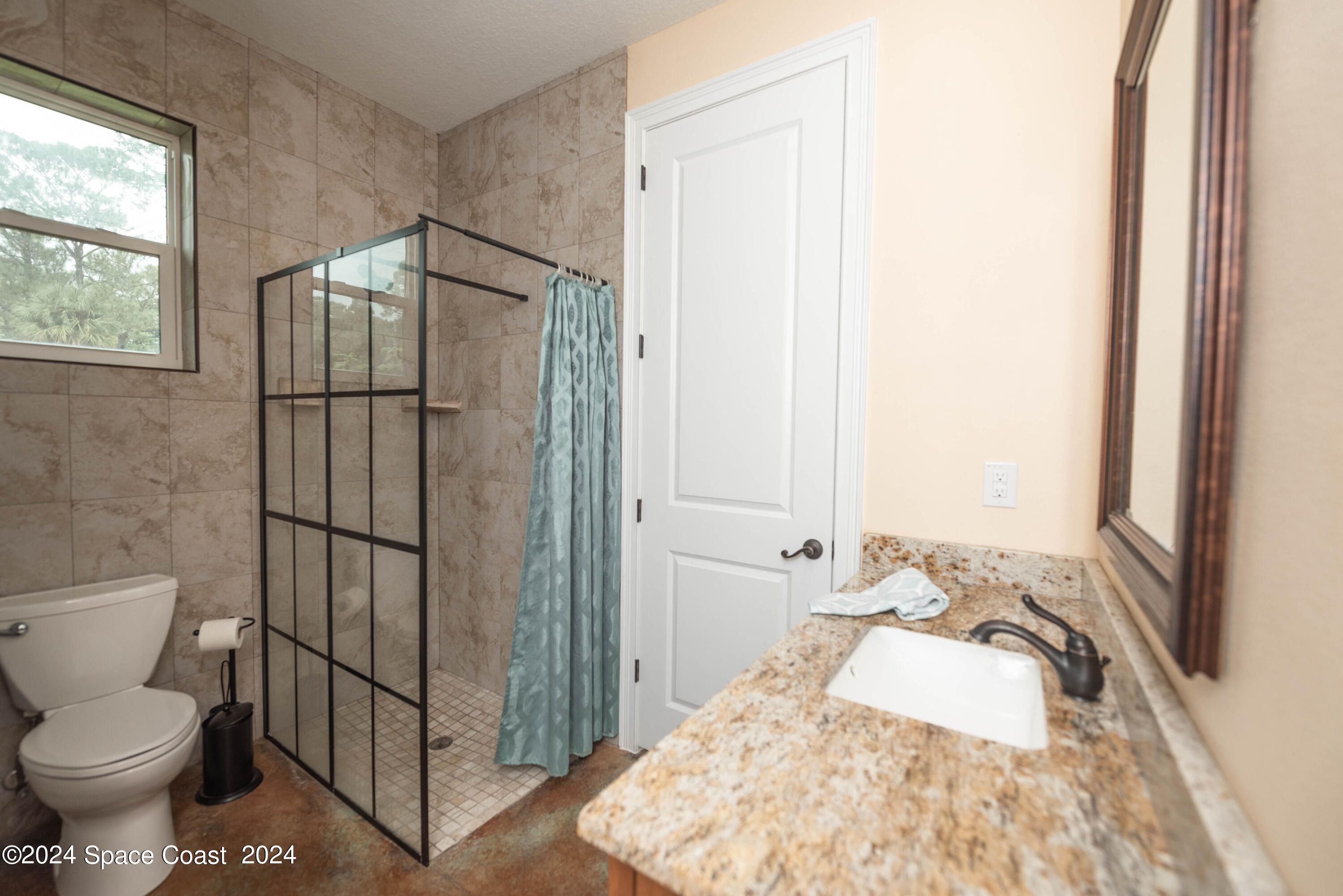 3750 Hield Road Melbourne, FL 32904 - Photo 38 of 63 a bathroom with a sink toilet and shower