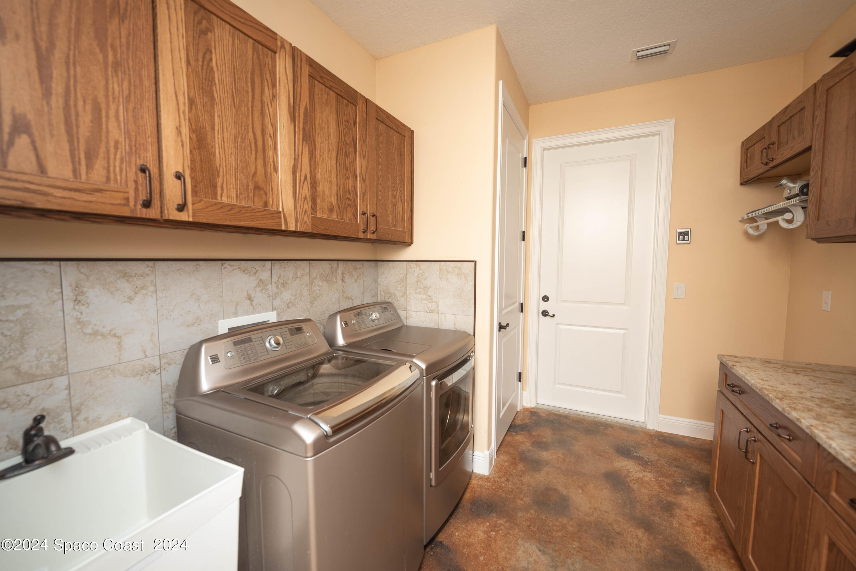 3750 Hield Road Melbourne, FL 32904 - Photo 43 of 63 a kitchen with a sink stove and cabinets