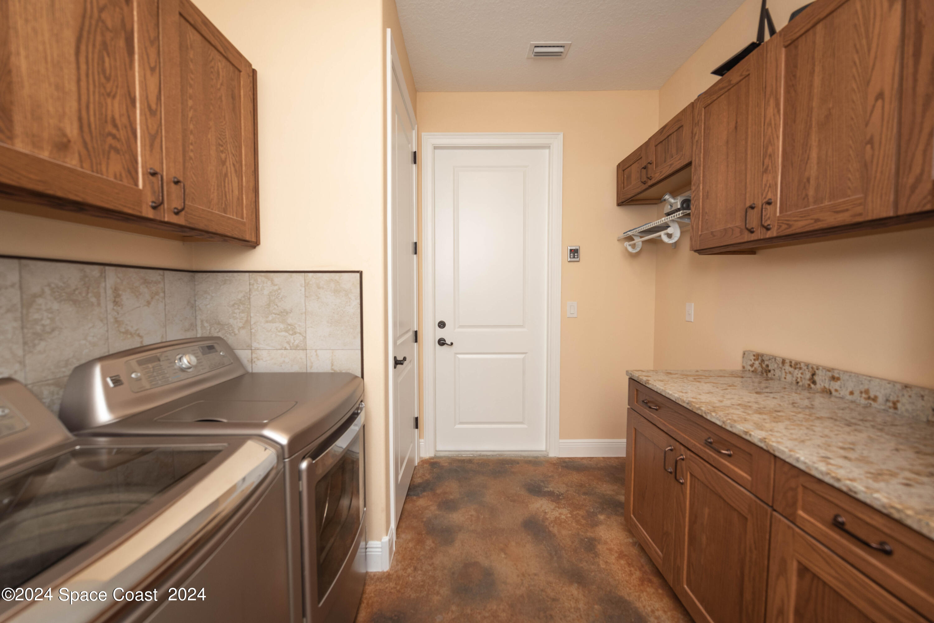 3750 Hield Road Melbourne, FL 32904 - Photo 44 of 63 a kitchen with a sink stove and cabinets
