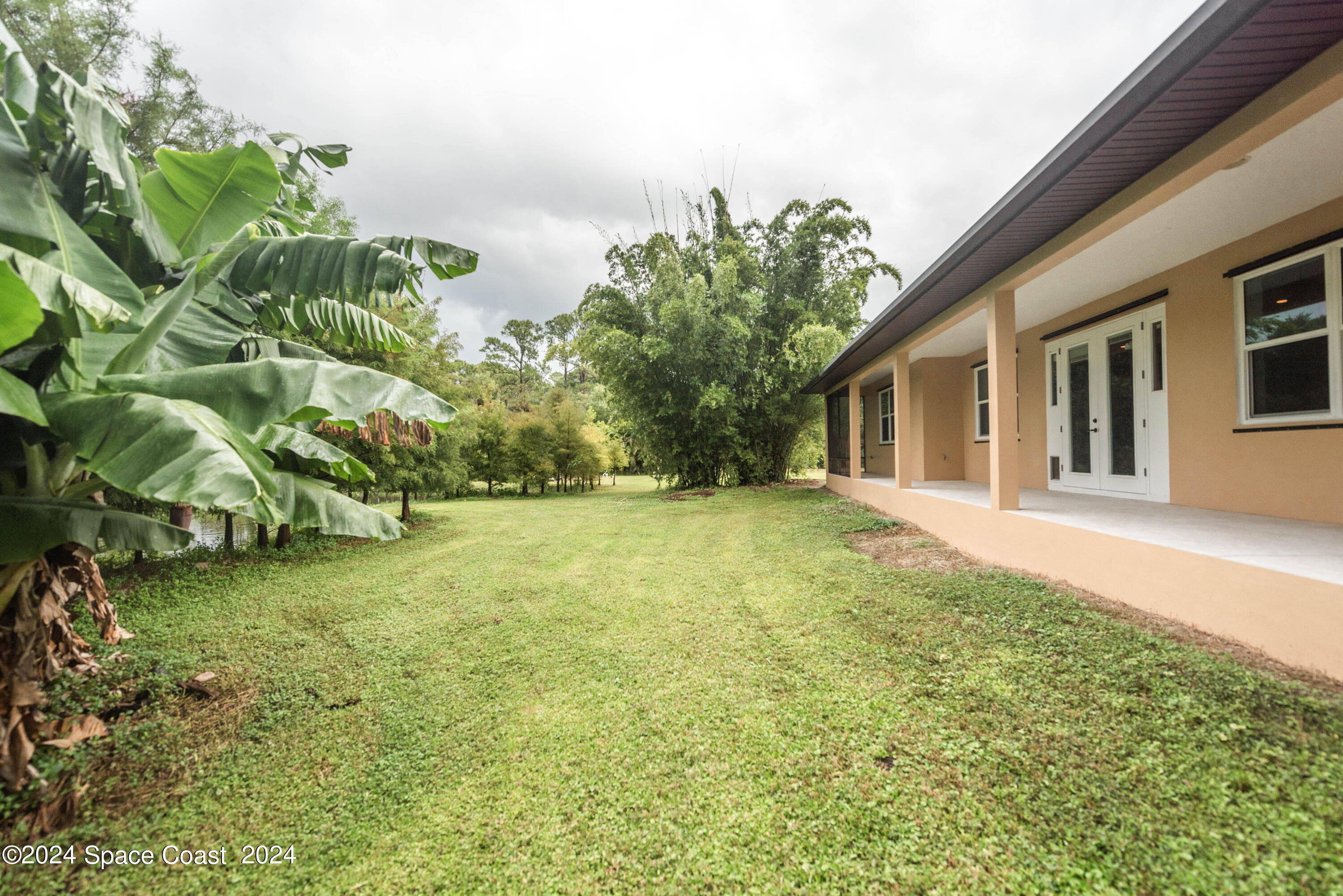 3750 Hield Road Melbourne, FL 32904 - Photo 50 of 63 a backyard of a house with lots of green space