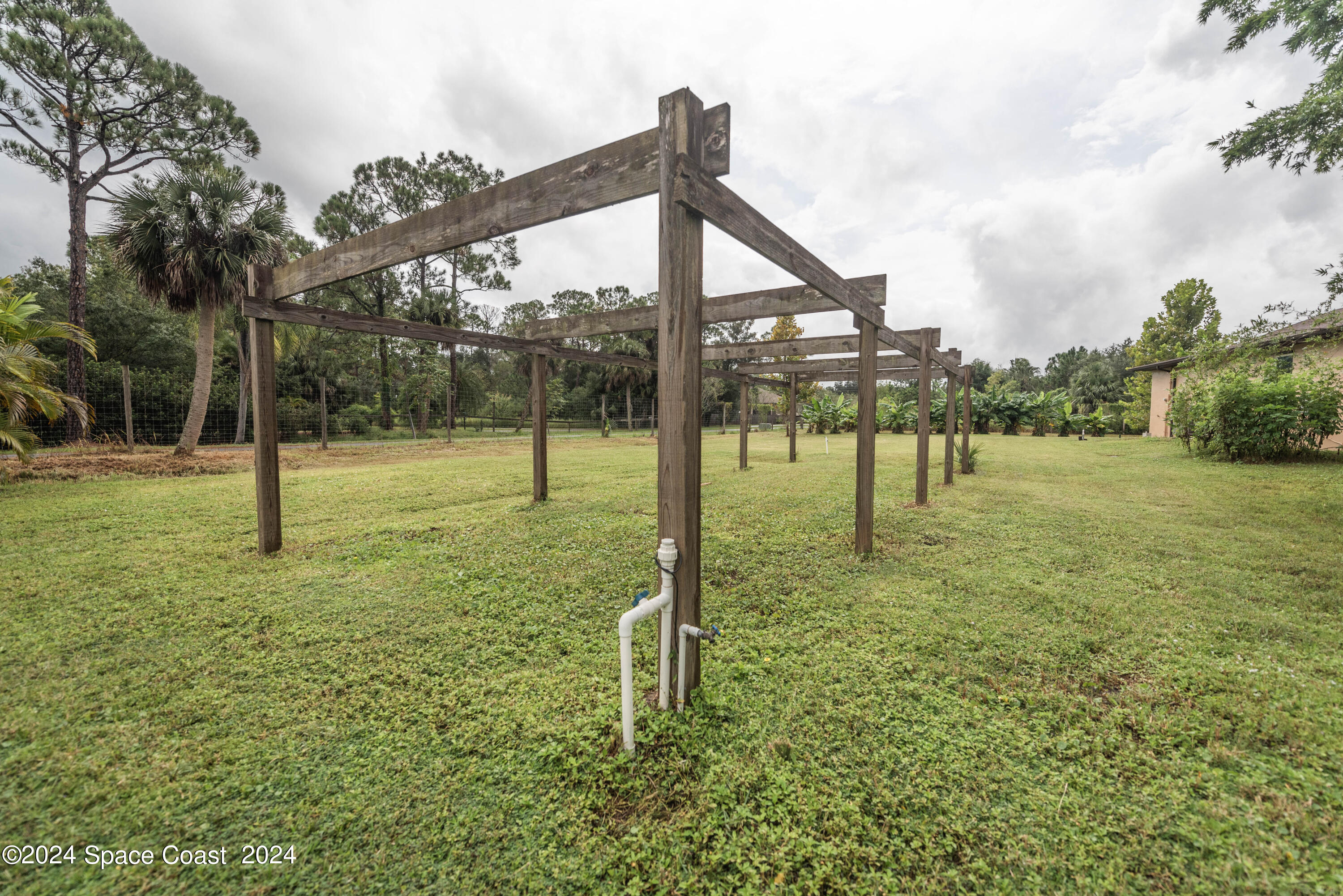 3750 Hield Road Melbourne, FL 32904 - Photo 55 of 63 a backyard of a house with lots of green space and garden