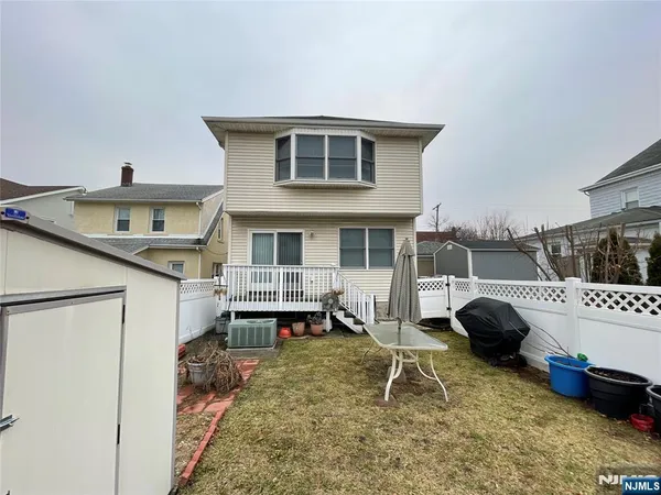 a living room with furniture flowerpot and wooden floor