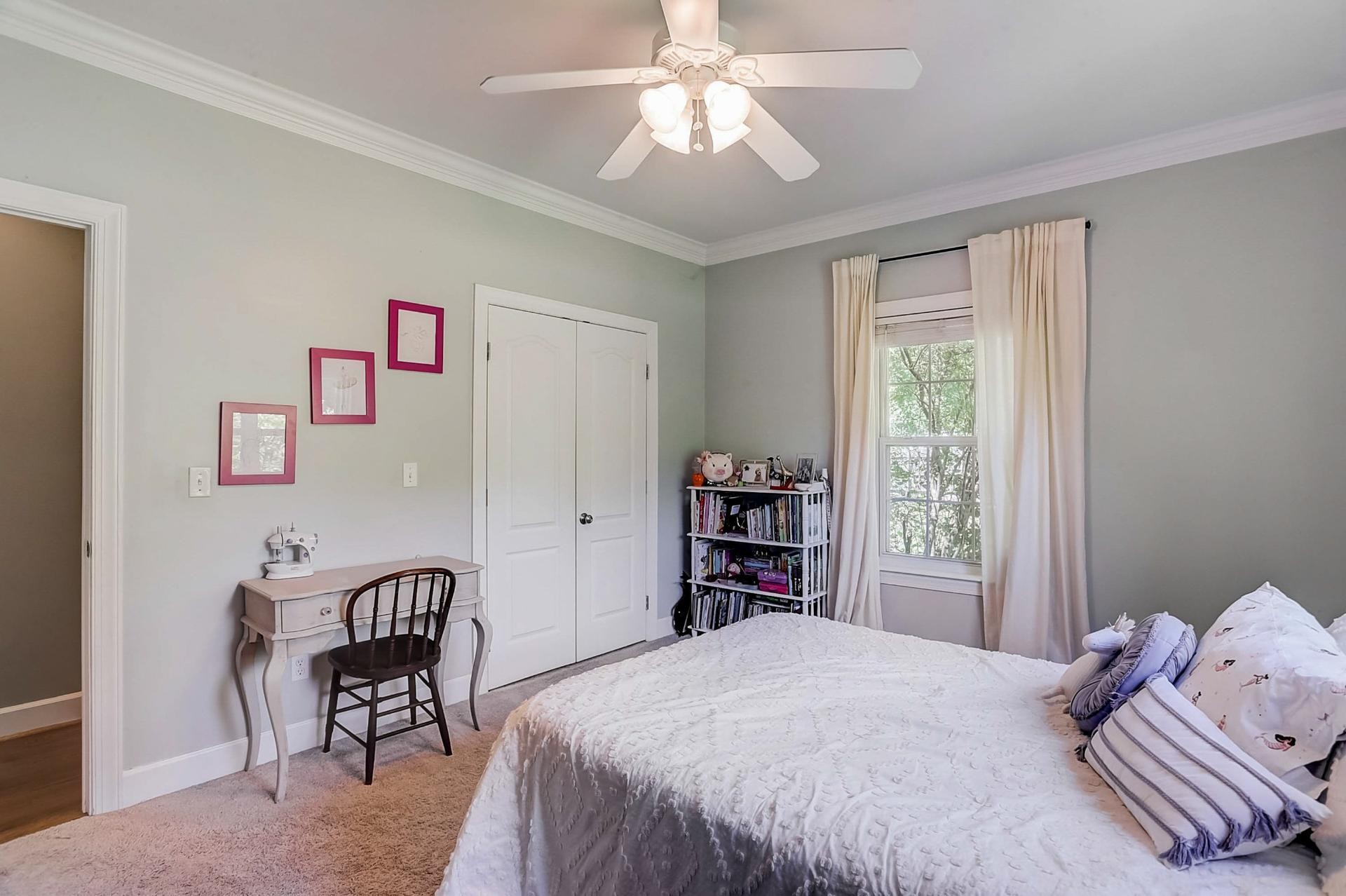 7532 King Road Fairview, TN 37062 - Photo 30 of 64 a bedroom with a bed and a chandelier