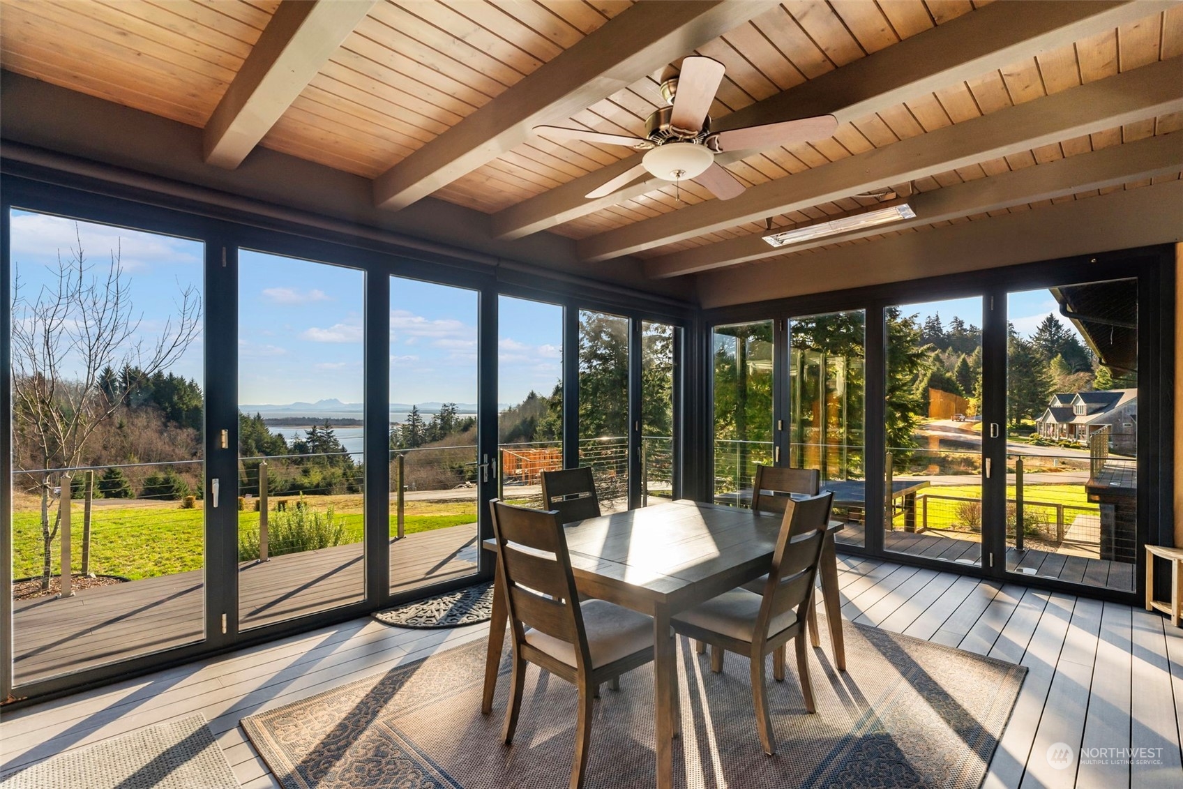 3010 Lighthouse Keepers Road Ilwaco, WA 98624 - Photo 11 of 38 a view of a dining room with furniture large windows and wooden floor