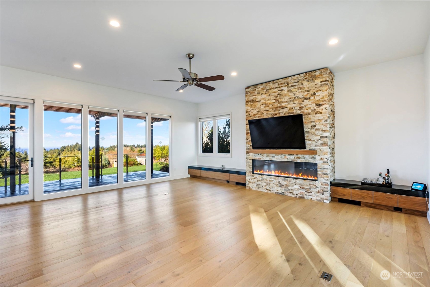 3010 Lighthouse Keepers Road Ilwaco, WA 98624 - Photo 5 of 38 a view of a livingroom with furniture a flat screen tv and floor to ceiling window
