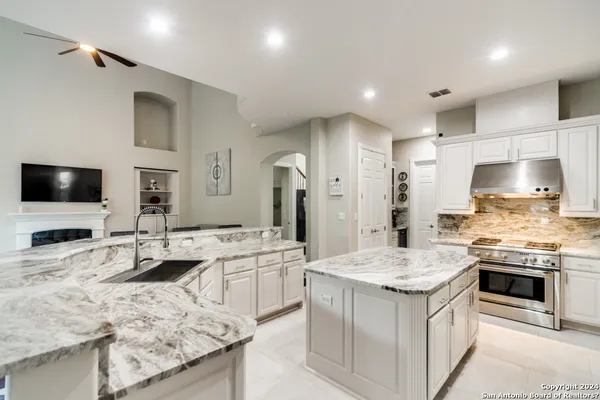 a large kitchen with kitchen island a sink stove and refrigerator