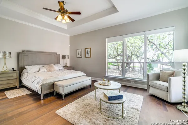 a bedroom with a bed a couch and a large window