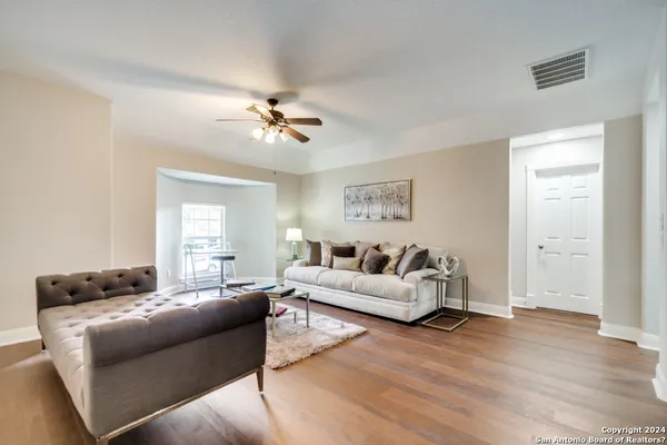 a living room with furniture and wooden floor