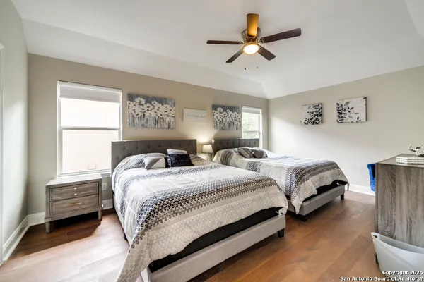 a bedroom with a bed a window and a chandelier