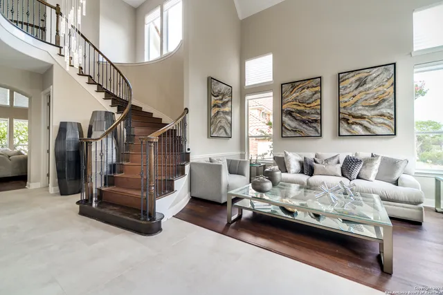a living room with furniture and a baby crib