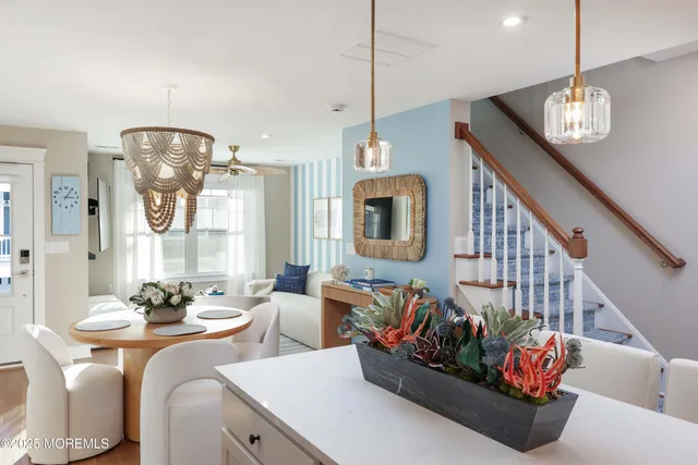 a living room with furniture chandelier and a view of kitchen