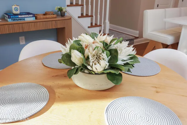 a vase of flowers sitting on a dining table