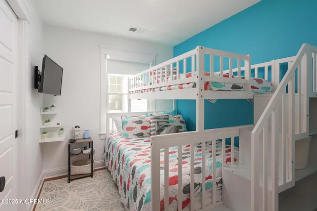 a view of a bedroom with furniture and toys