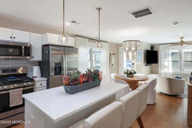 a kitchen with sink a stove and cabinets