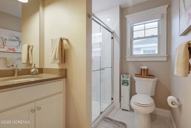 a bathroom with a granite countertop sink toilet and shower