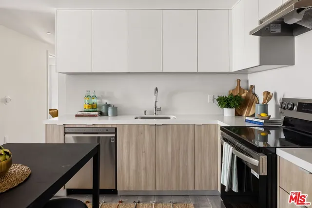 a kitchen with appliances cabinets and a counter top space