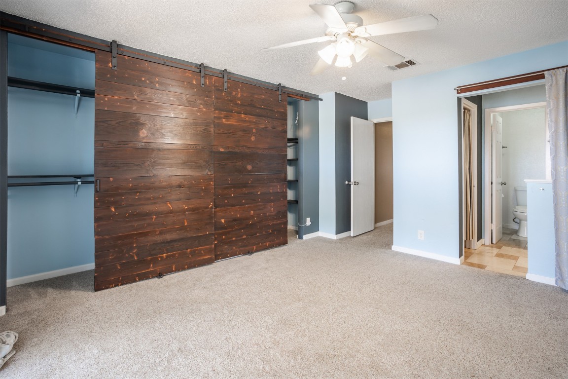 1720 Timber Ridge Drive Austin, TX 78741 - Photo 11 of 30 Master bedroom with barn doors